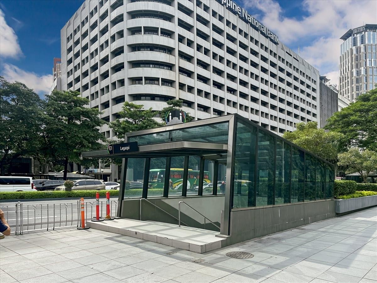 Exterior entrance of the PNB Makati Center on Ayala Avenue with glass subway access in front.