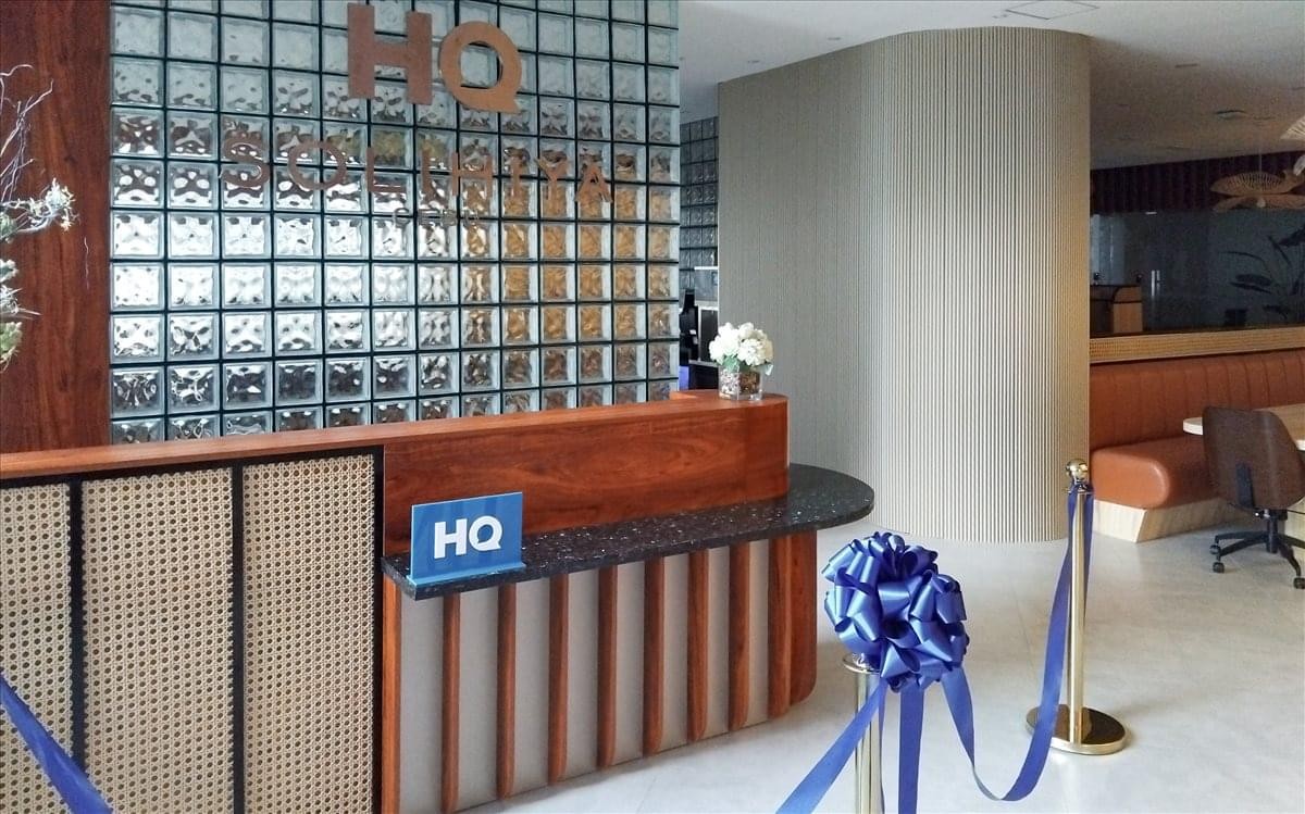 Reception area of the 12th Floor Cebu Exchange Tower, Salinas Drive with a wood-paneled desk and glass block wall.