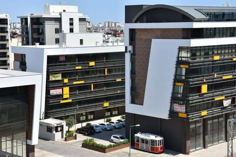 Exterior view of the modern white and brown Midtown Plaza building.