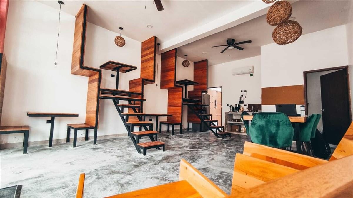 Spacious communal lounge at 388 Sukhumvit Road with warm wood accents and tiered seating areas.
