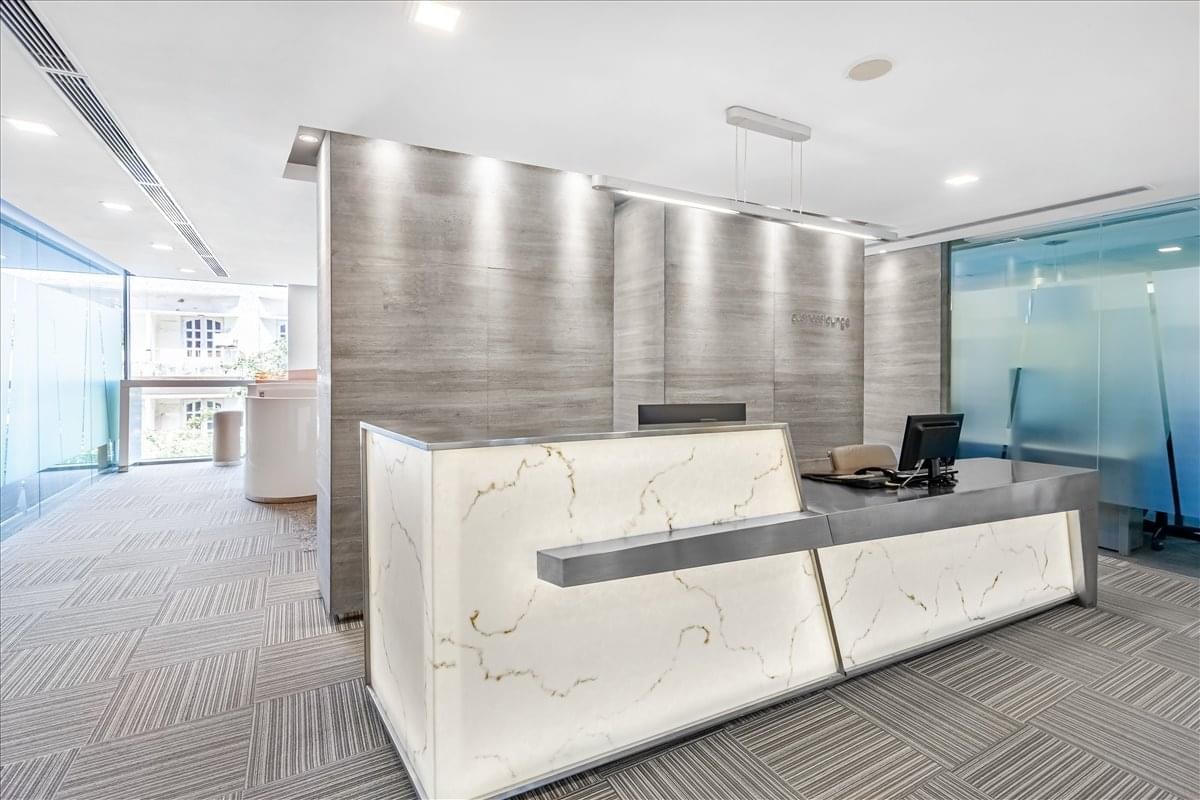 Modern marble and wood reception desk at 41A Ly Thai To, Level 5, Hanoi, Vietnam.