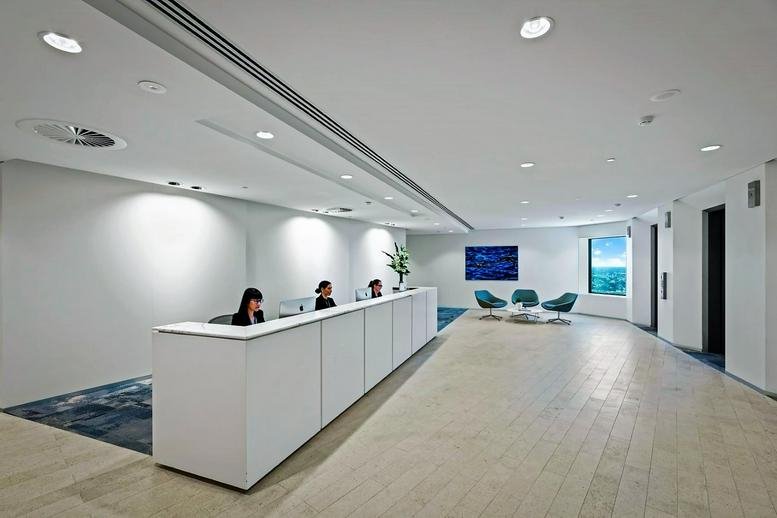 Reception area at BankWest Tower, 108 St. Georges Terrace featuring a white desk and blue seating.