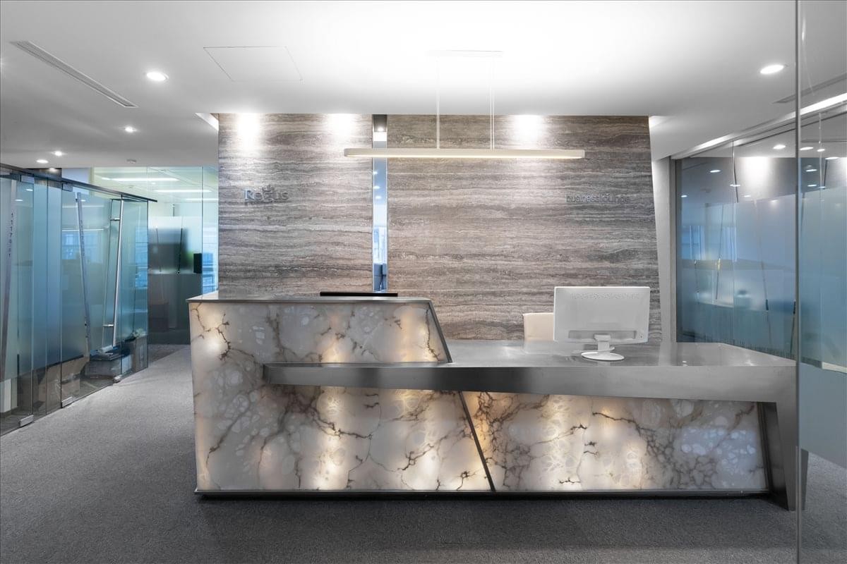 The sleek, stone-clad reception desk at Central Towers, 567 Lan Gao Road, Shanghai.