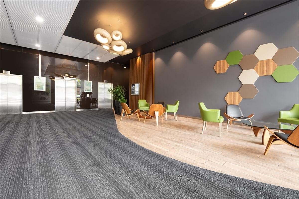 Spacious lobby at Level 5, 7 Eden Park Drive featuring colorful wall art and designer seating.