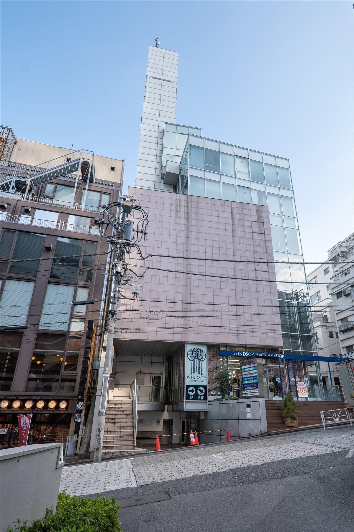 Exterior view of the multi-story Fuji building 40 with its modern glass and stone facade.