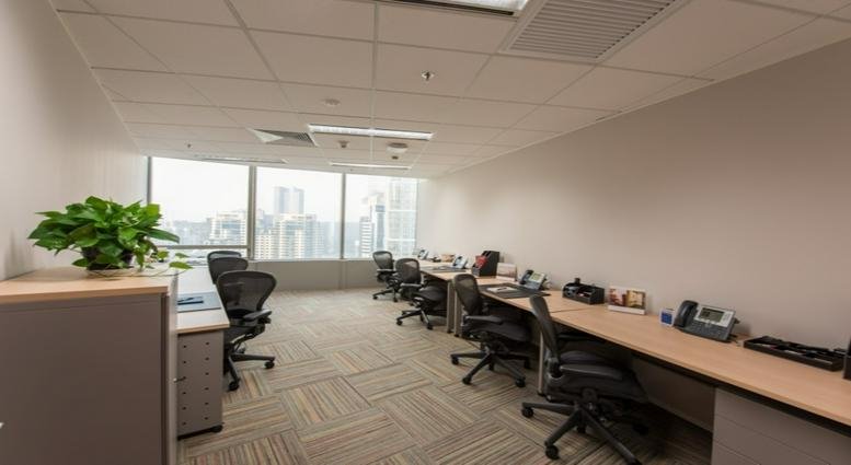 Spacious open-plan workspace at Hyundai Motor Tower with ergonomic chairs and expansive city views.