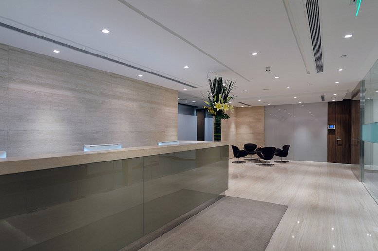 Polished reception desk at the Hyundai Motor Tower with a marble floor and floral centerpiece.