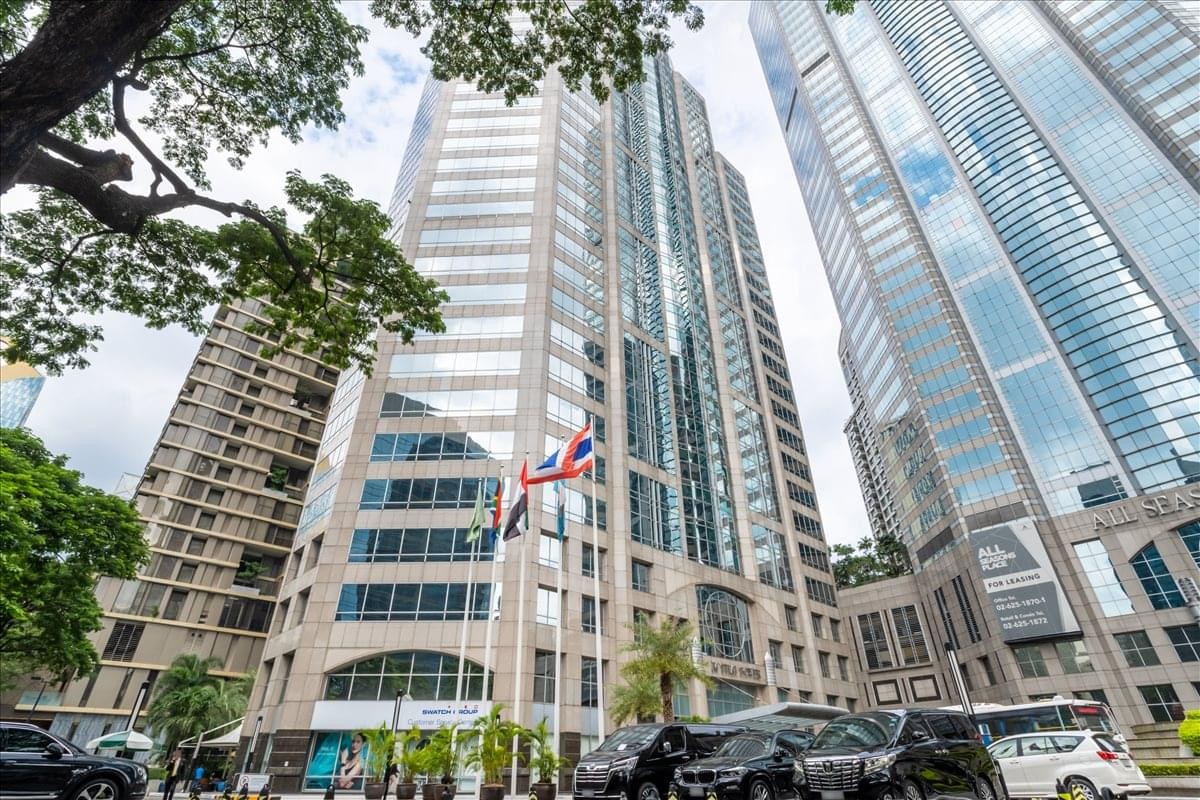 Exterior view of the soaring glass and stone facade of M Thai Tower.