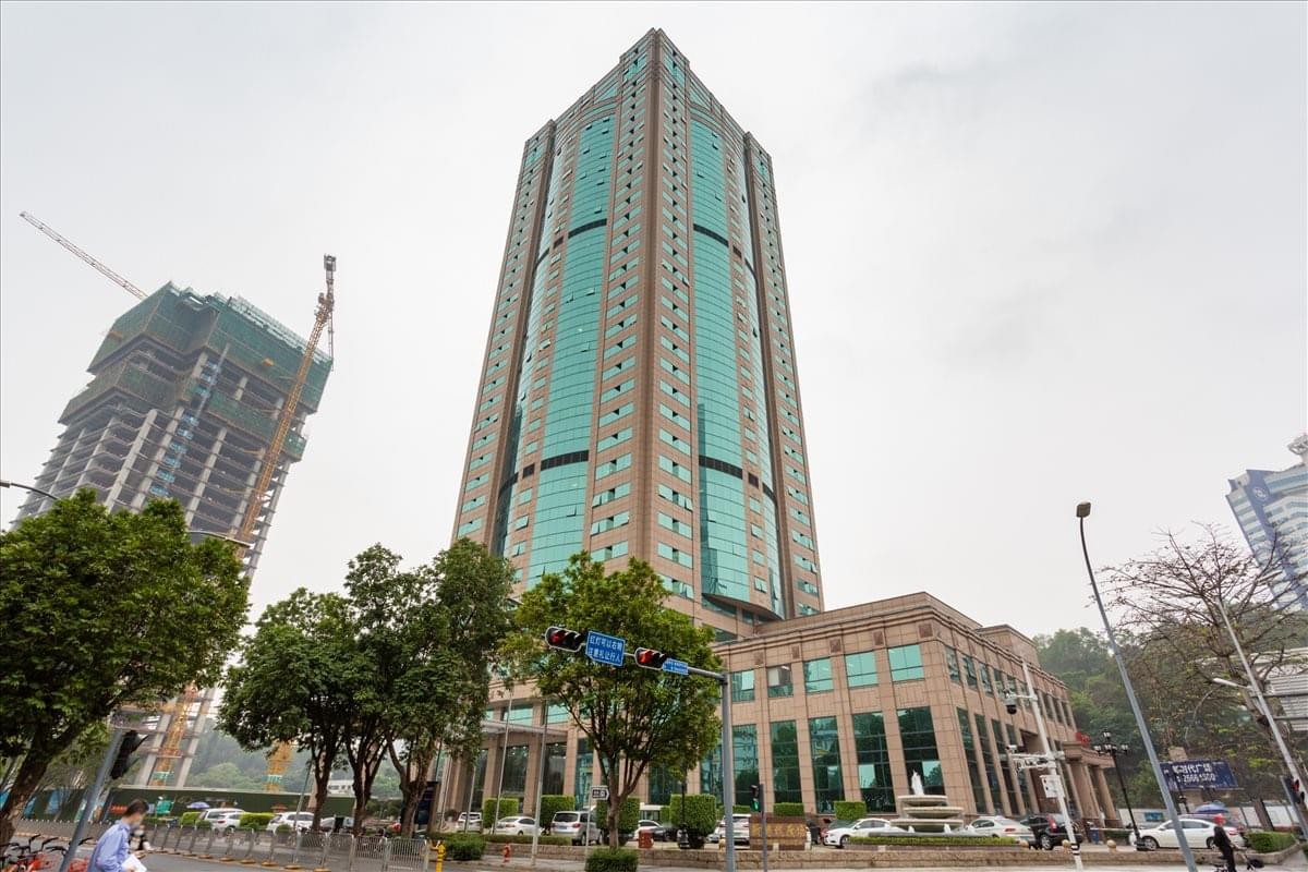 Exterior view of the soaring glass and stone facade of New Times Plaza.