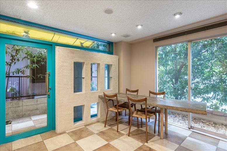 Communal dining area with teal-framed glass doors and a checkered floor.
