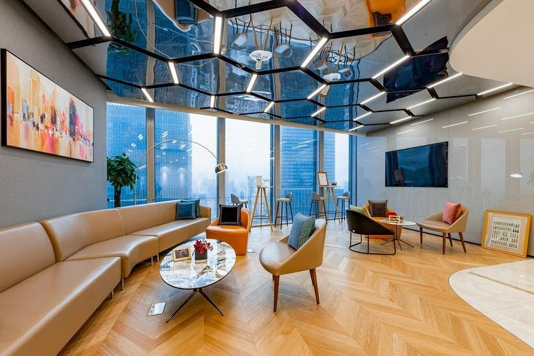 Spacious lounge at 38F Park Place with a geometric mirrored ceiling and city views.