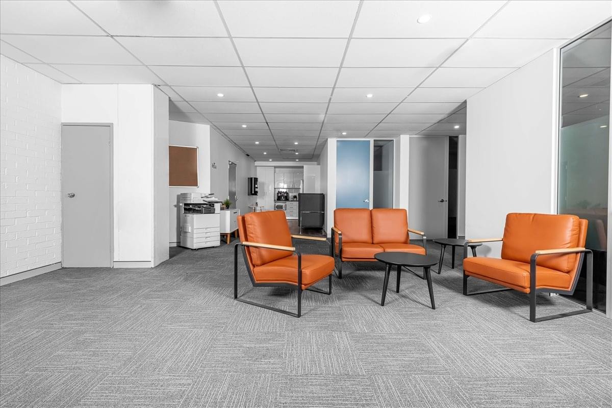 Spacious lounge area at 564 Princess Highway, Rockdale, Sydney, Australia with orange leather armchairs.