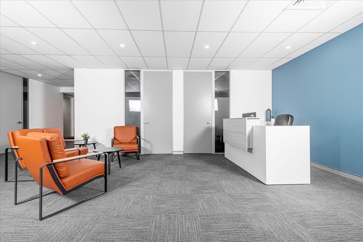 Bright reception area at 564 Princess Highway, Rockdale, Sydney, Australia with a white desk and orange seating.