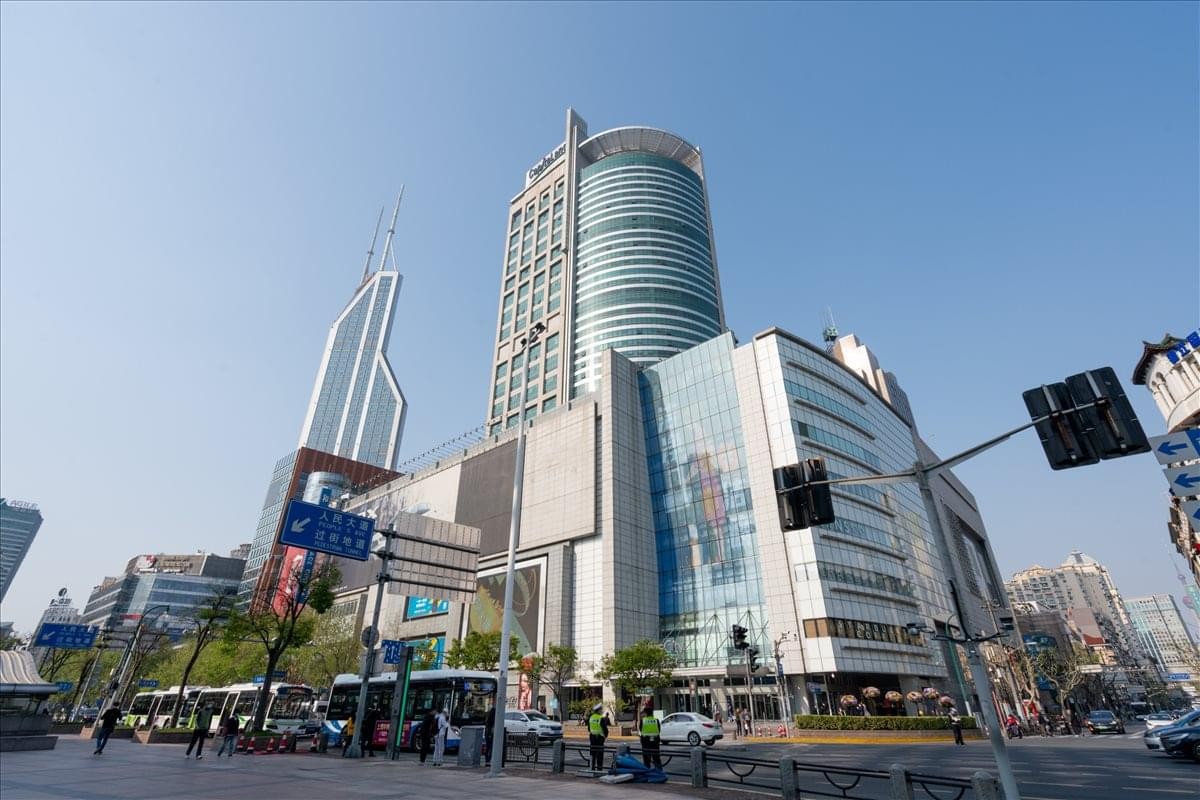 Exterior view of the contemporary glass and steel Raffles City tower against a clear blue sky.