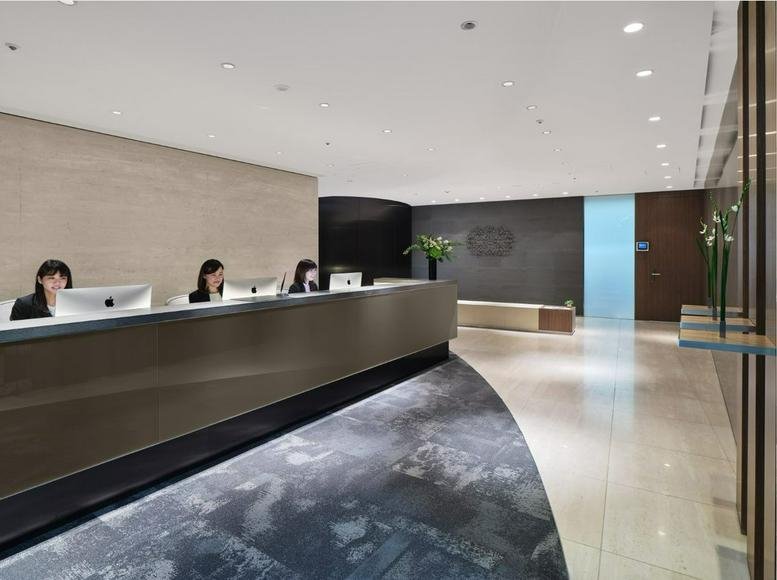 Professional reception desk with wood paneling and minimalist lighting.