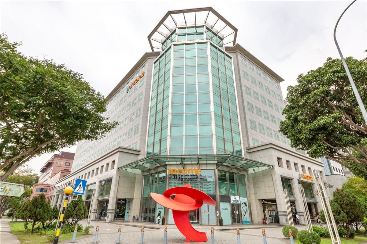 Exterior view of the glass-facade Tampines Junction building featuring a red modern sculpture.