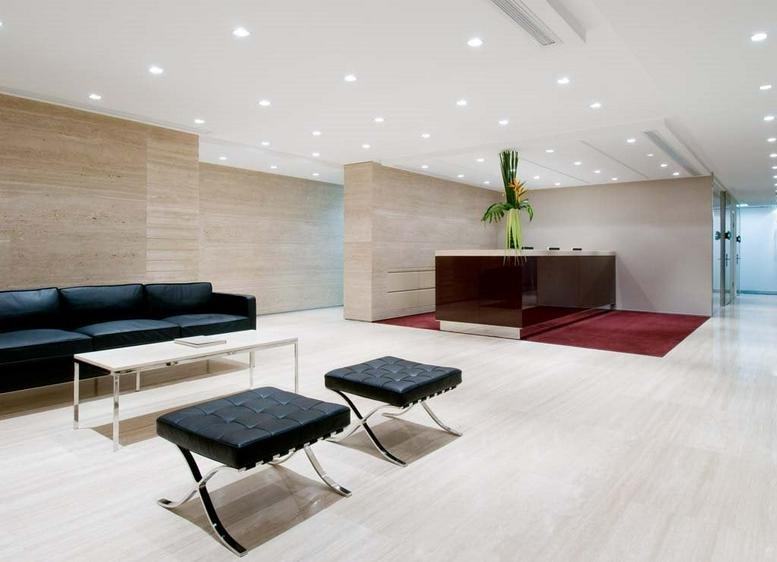Bright and spacious reception lobby at The Exchange Tower 2 with marble flooring.