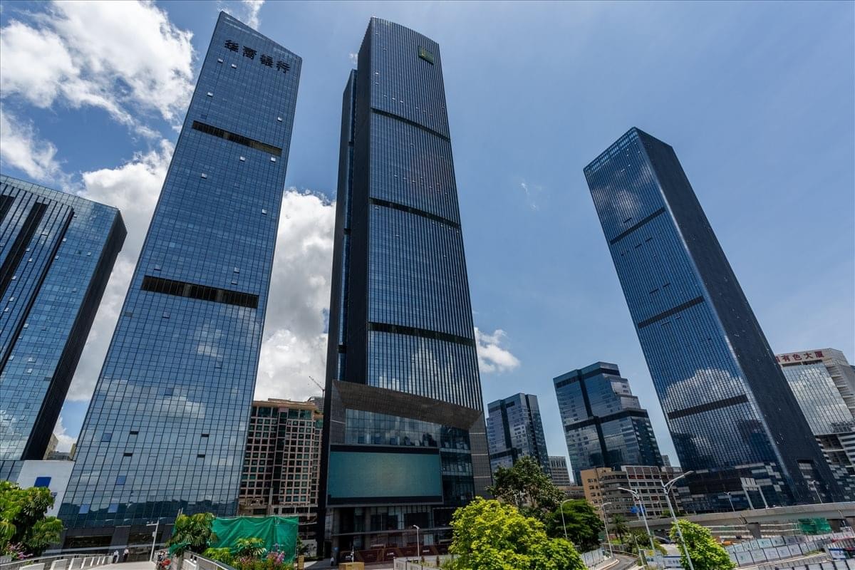 Low angle exterior of the modern glass skyscrapers at Tower A, NEO, Shennan Avenue.