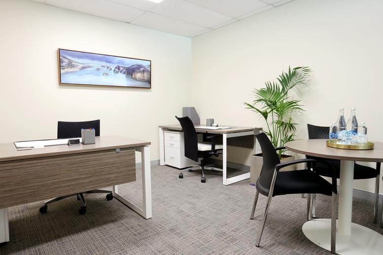 Private office suite at 45 Ventnor Avenue, West Perth, Australia with two wood-grain desks and landscape wall art.