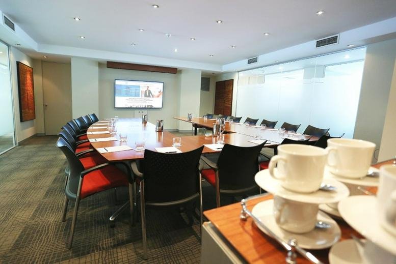 Modern conference room at 45 Ventnor Avenue, West Perth, Australia with a U-shaped table and coffee setup.