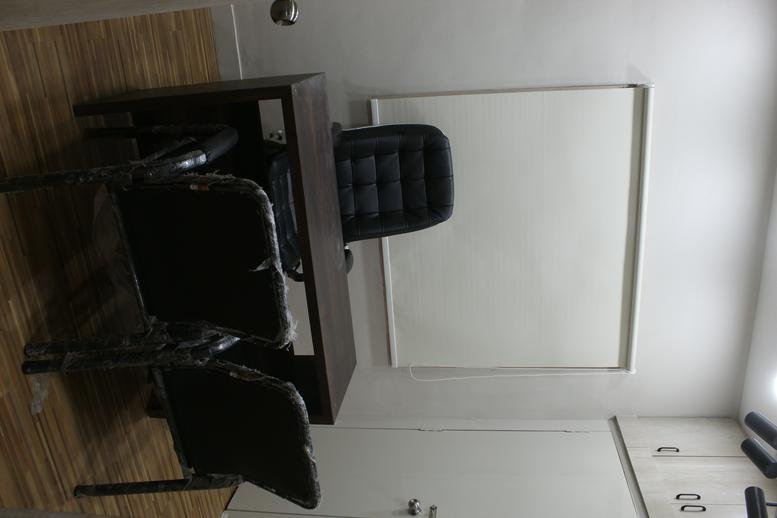 Interior office space at Plot No-120, Lala Lajpatray Society, featuring wood flooring and a dark desk setup.