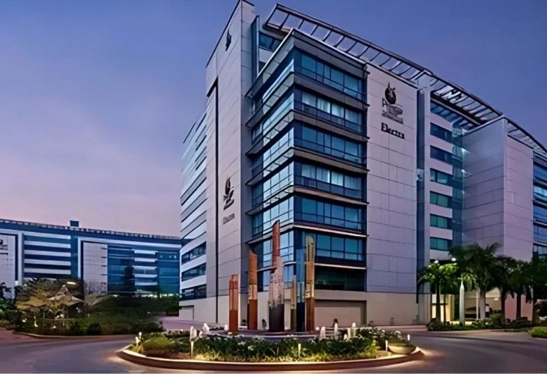 Exterior view of Redbrick Offices, Bangalore with modern glass facade and landscaped entrance.