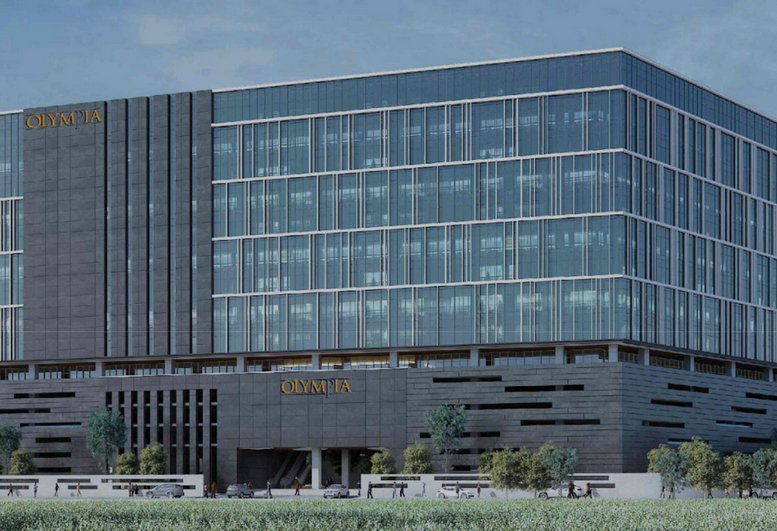 Exterior view of the modern glass-facade building at Redbrick Offices, Olympia Cyberspace.