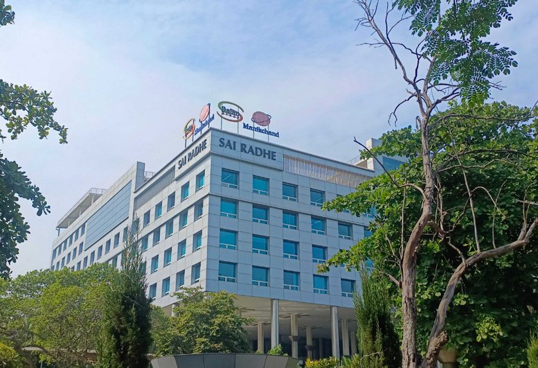 Exterior view of the silver and glass facade at Sai Radhe Corporate Park.