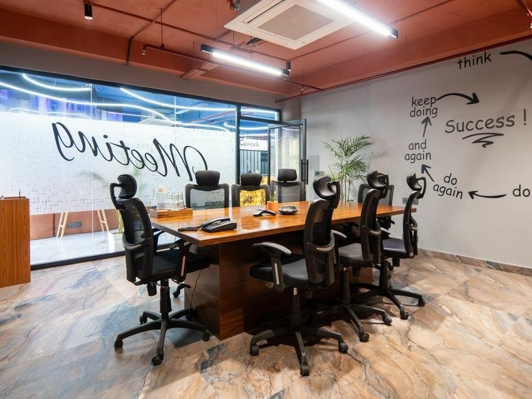 Spacious boardroom at Sector 17, SCO 142, 143, 144 with a wooden table and success-themed wall art.