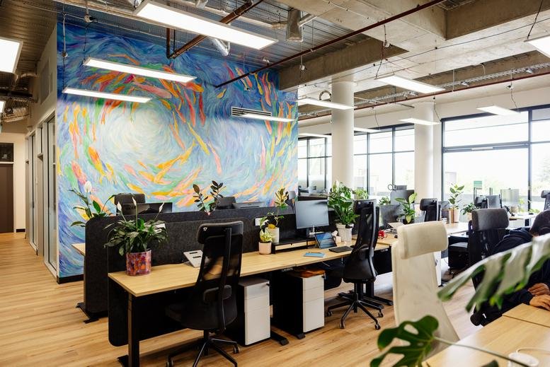 Spacious open-plan workspace at 1/ 132 Prospect Road featuring a vibrant abstract mural and multiple workstations.