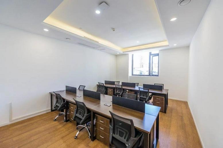 Spacious professional workspace with wooden desks at 1-2F, No 845, Renmin Road, Shanghai.