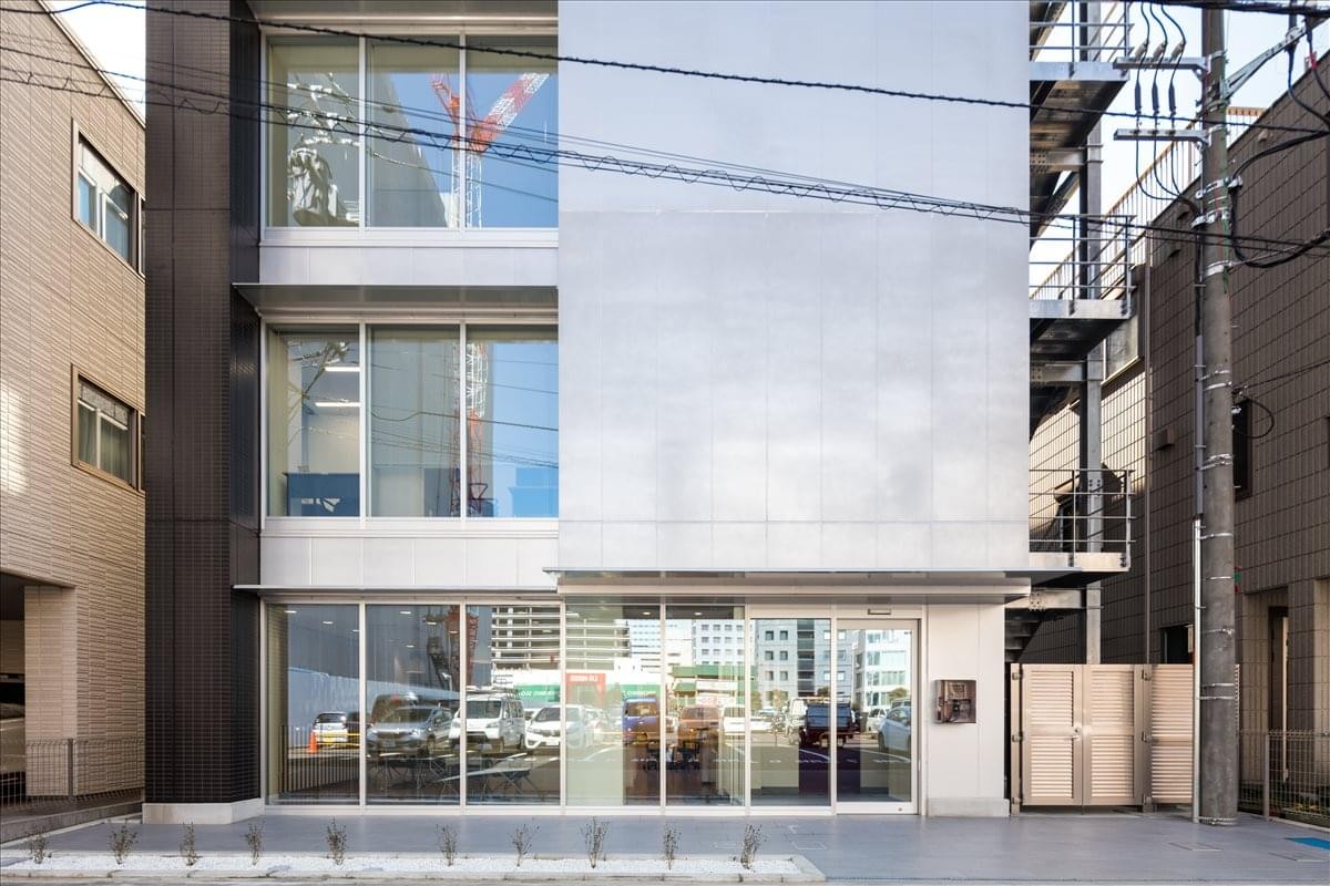 Modern exterior of the Sakuragicho Omiya-Ku, Saitama-Shi building with a glass facade and metal accents.