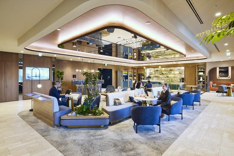 Spacious communal lounge with a unique reflective ceiling and warm lighting.