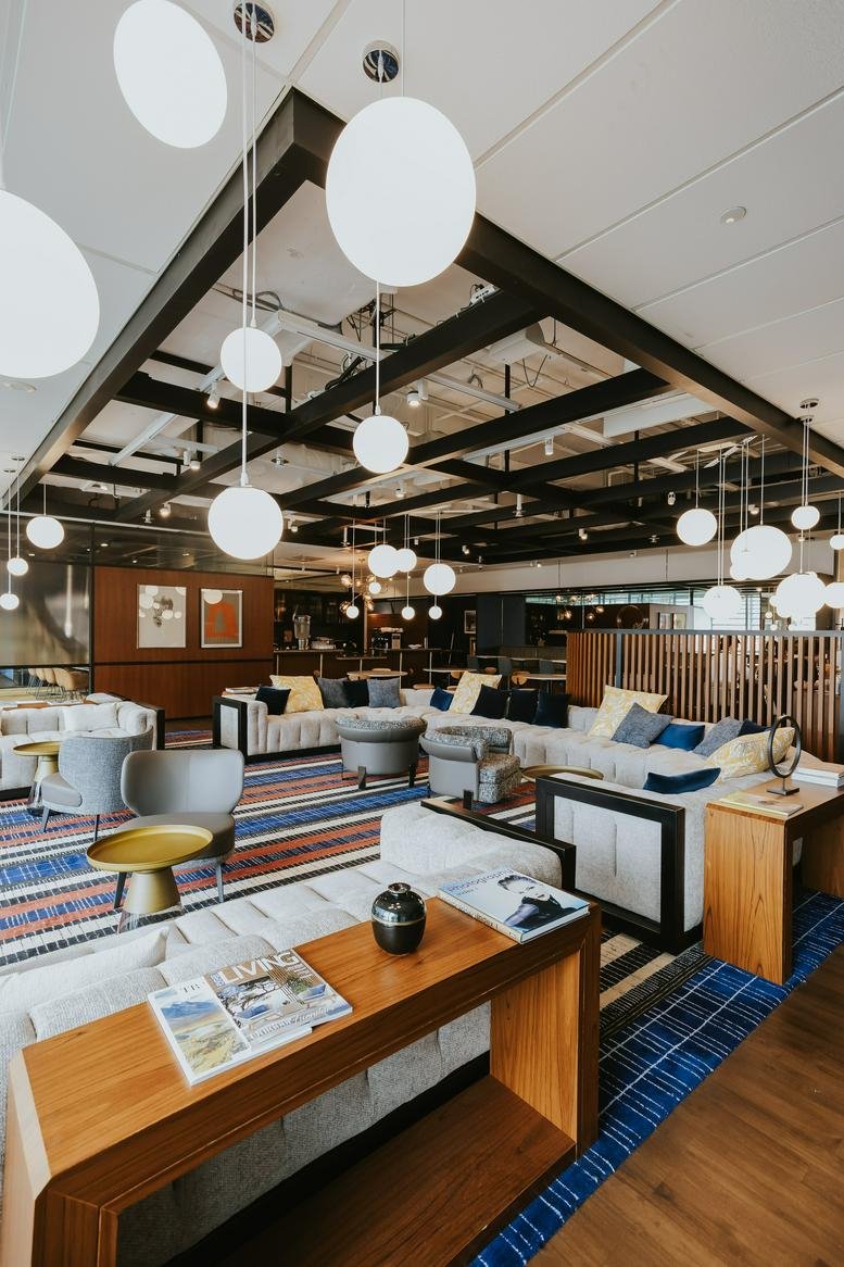 Spacious communal lounge at 1 George Street, Level 10 with sphere pendant lights and modern seating.