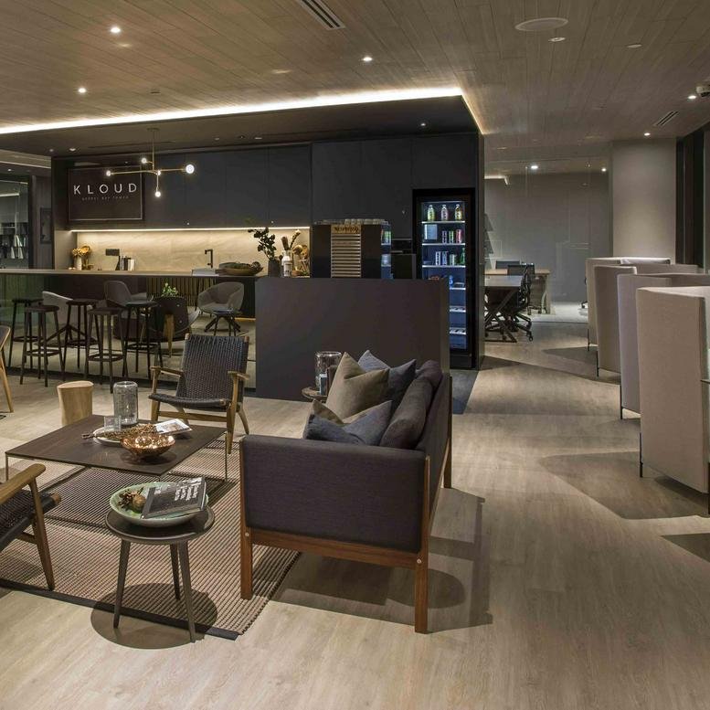 Modern lounge at 1 HarbourFront Avenue, Level 13 featuring contemporary seating and an integrated kitchenette area.
