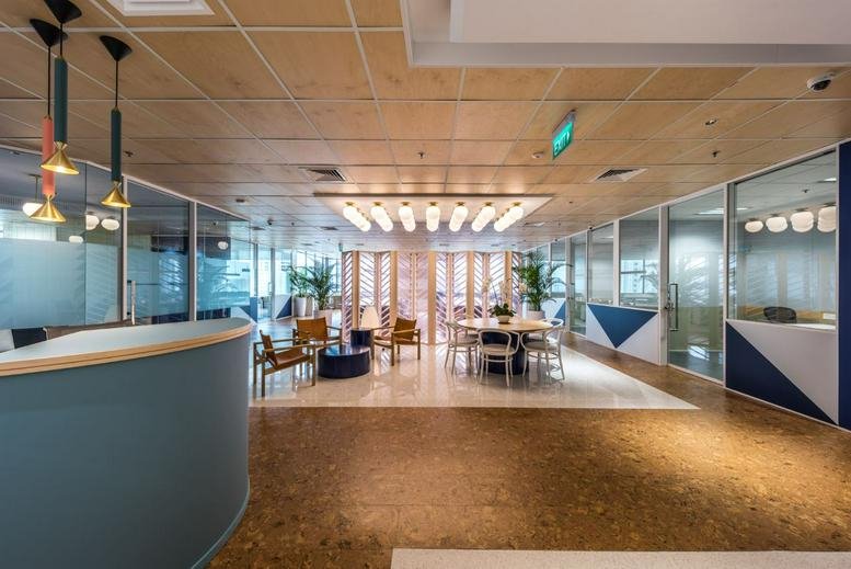 Spacious reception area with wooden ceilings and modern lighting at Great World City Office, East tower.