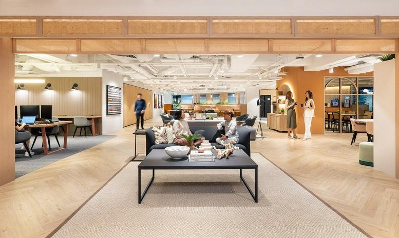 Spacious communal lounge at International Plaza with warm wood accents and contemporary furniture.