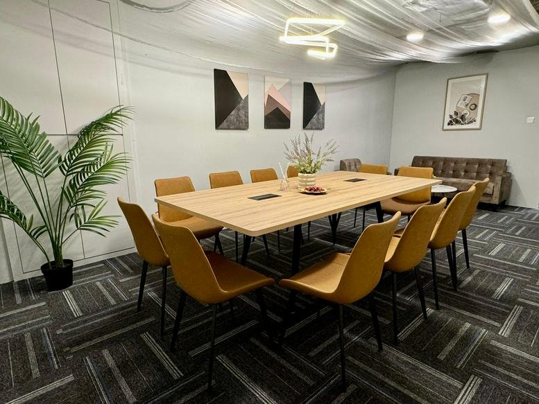 Spacious meeting room with a wooden table, yellow chairs, and modern lighting at 10 Anson Road, No. 33-15, Singapore.