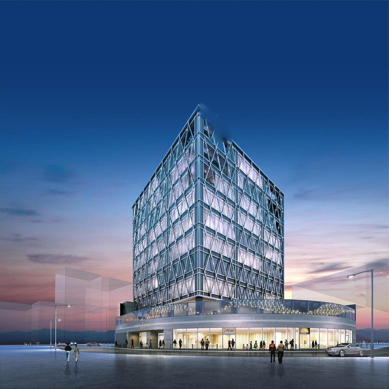 Ground level view of the modern building facade at dusk with lit windows.