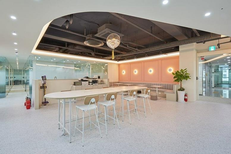 Spacious communal area with seating and decorative lighting.