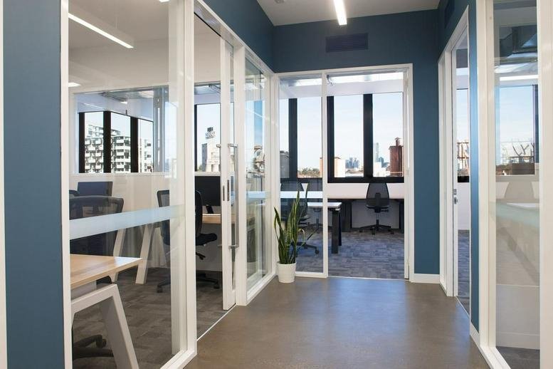 Bright common area at Level 2 & 3, 100 Cubitt Street, Cremorne, featuring polished floors and greenery.