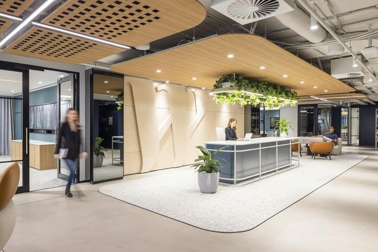 Modern reception desk at Level 5, 100 Market Street, Sydney with light wood ceilings and greenery.