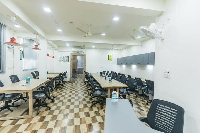 Open-plan coworking space at 101, Pratap Nagar, Mayur Vihar Ph. 1, New Delhi featuring rows of wooden desks.