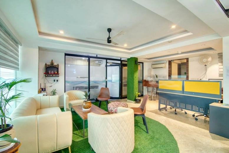 Bright reception area at 1095P, Huda Colony, Gurugram with white armchairs and green turf rugs.