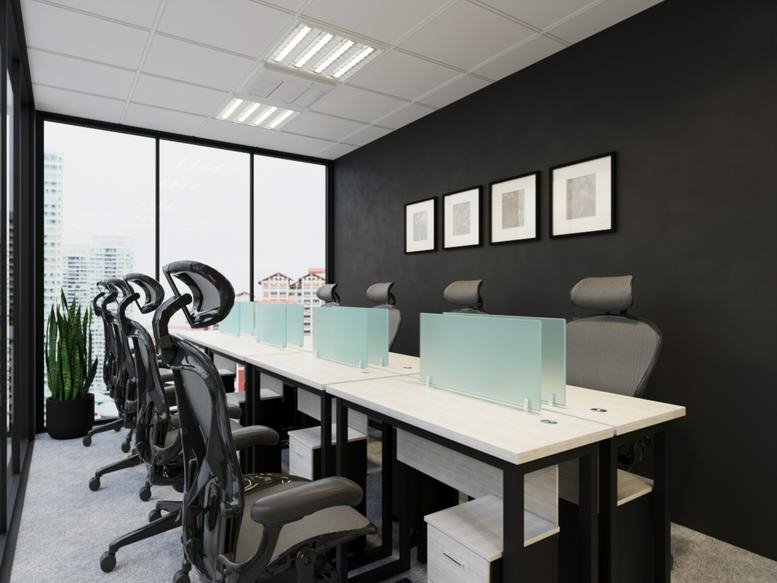 Brightly lit modern office workspace at 11/1 South Sathon Road featuring white desks and ergonomic black chairs.