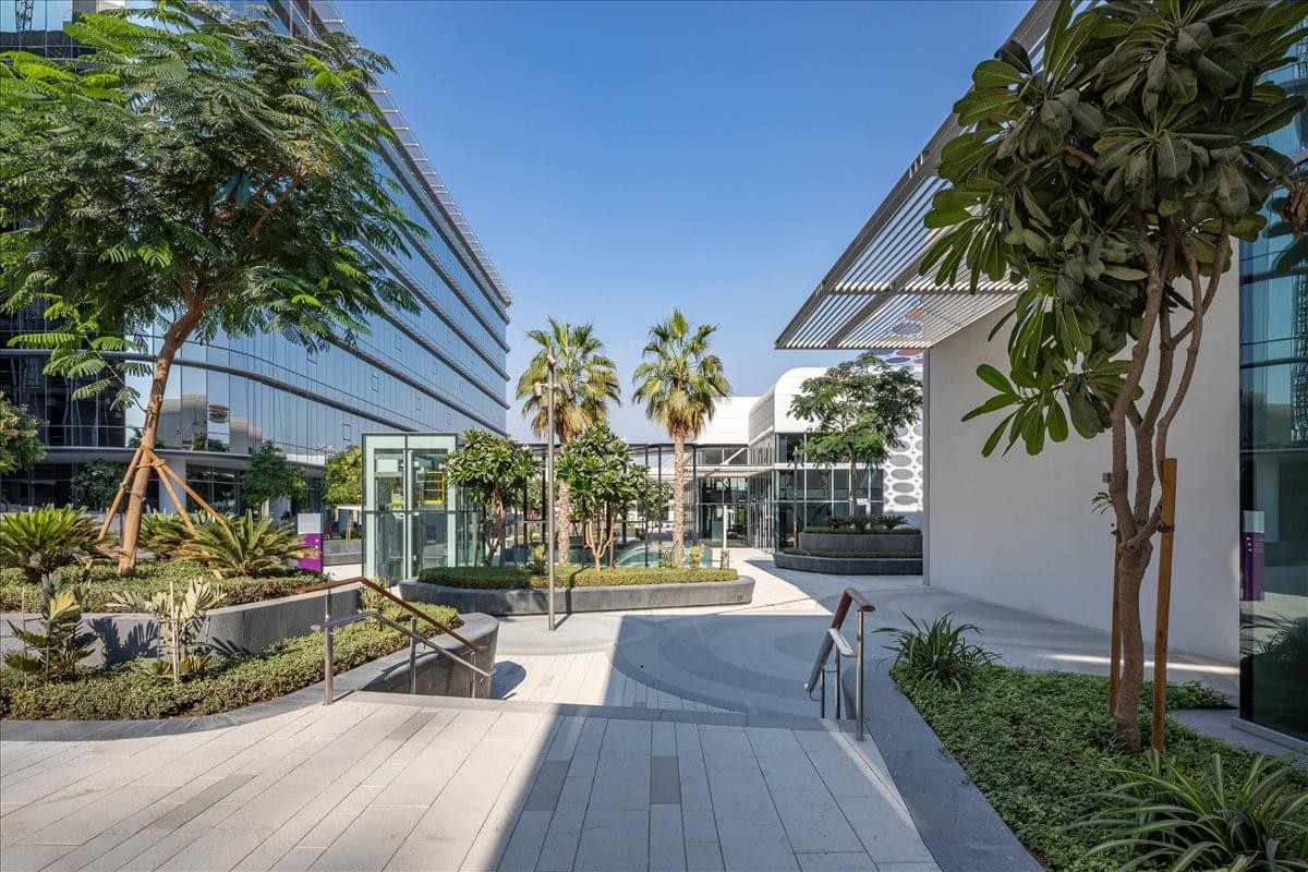 Exterior view of the contemporary Building B2, 11 17th Street with palm trees and a paved courtyard.