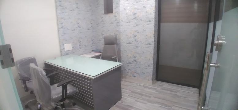 Private office at 111, 112, Roongta majestic with a glass-top desk and grey textured wallpaper.