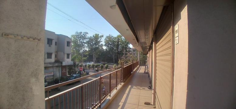 Exterior balcony view at Roongta Majestic overlooking the street with a metal railing.