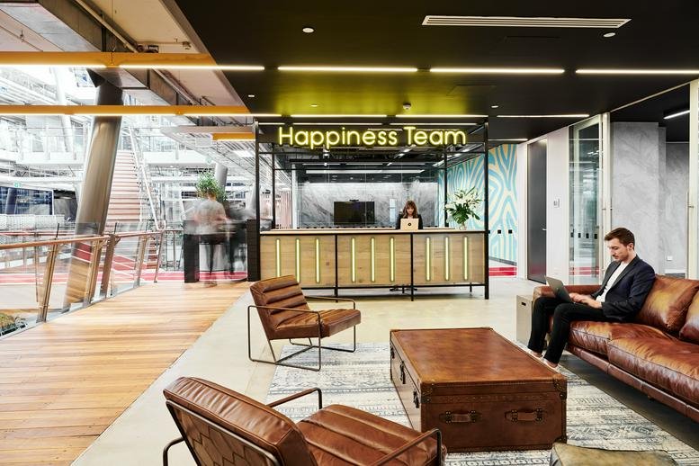 Spacious reception area with Happiness Team signage and leather seating at 111 Cecil St, South Melbourne VIC.