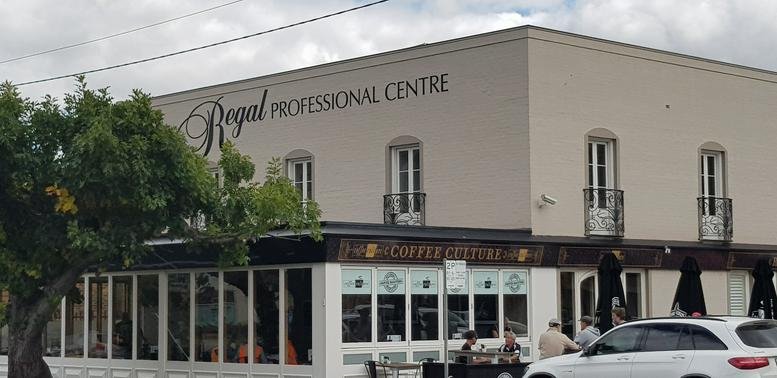 Exterior view of the Regal Professional Centre building with large signage and ground floor cafe.